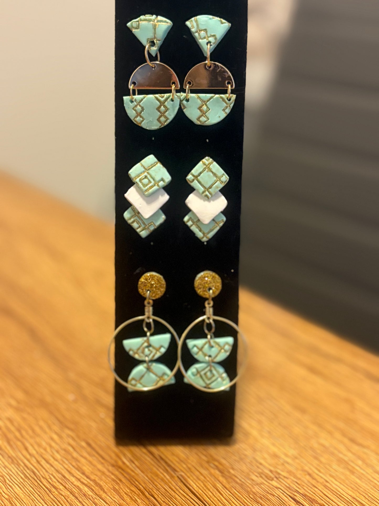 3 pairs of gold and turquoise/ southwestern style earrings.
